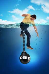 Man in a yellow shirt clings to a chain attached to a large black bomb labeled DEBT, sinking into deep blue water.